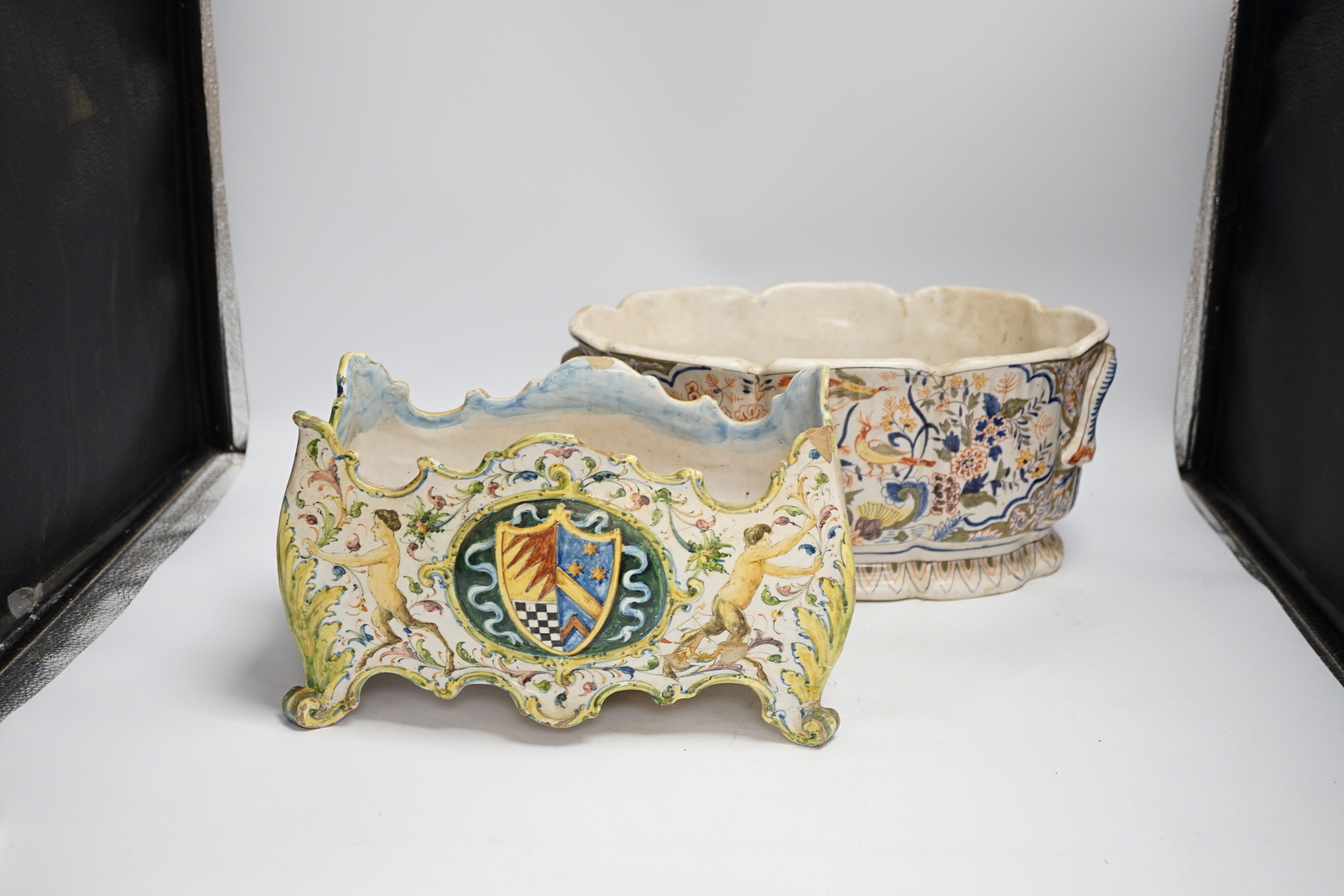 A Two French faience pottery planters, one with armorial crest and another, longer 34cm (2)